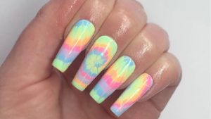 nail art tie and dye multicolore avec motifs géométriques sur ongles courts
