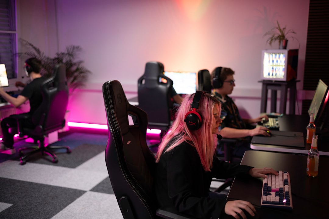A group of people sitting around a computer desk