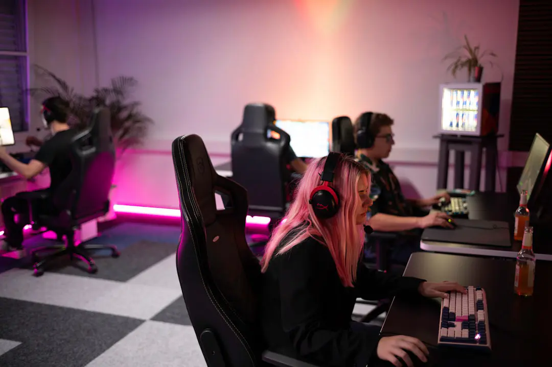 A group of people sitting around a computer desk
