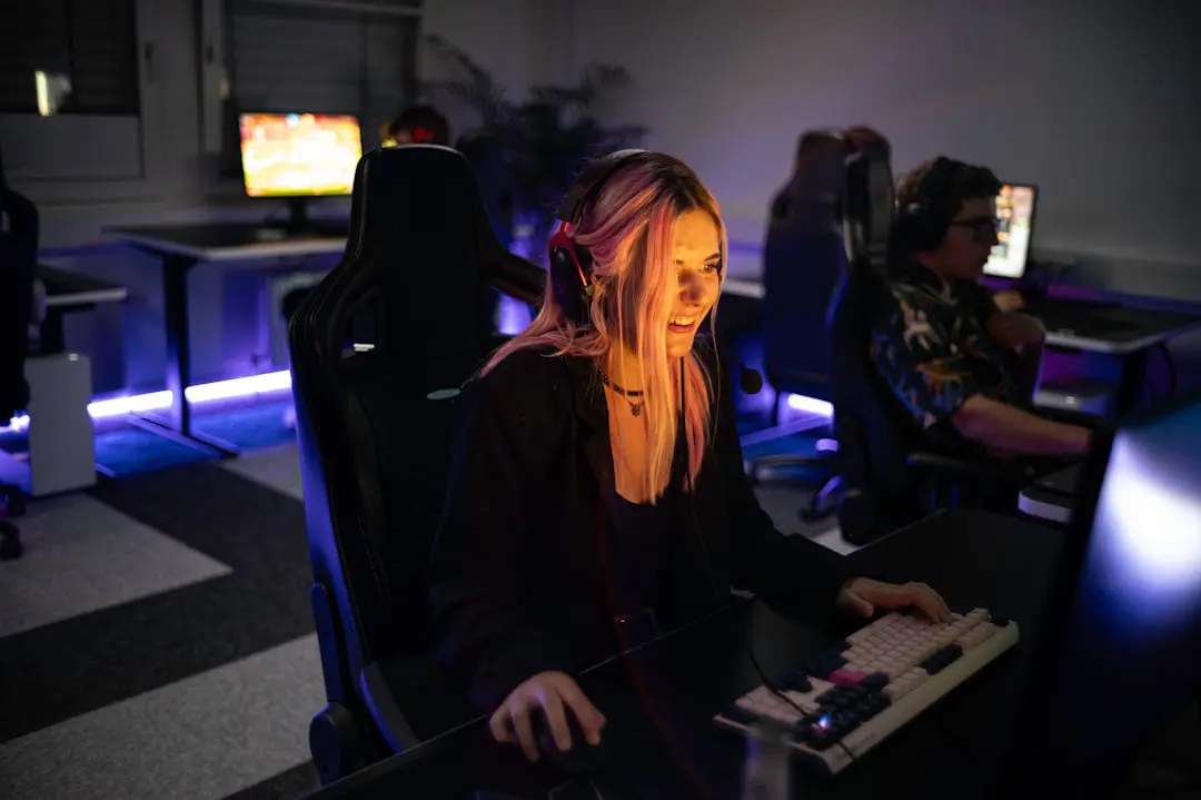 A woman sitting in front of a computer monitor